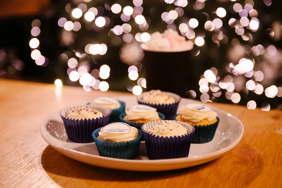 HSBA Garden Railway branded cupcakes at the Railway Cafe with Christmas lights behind