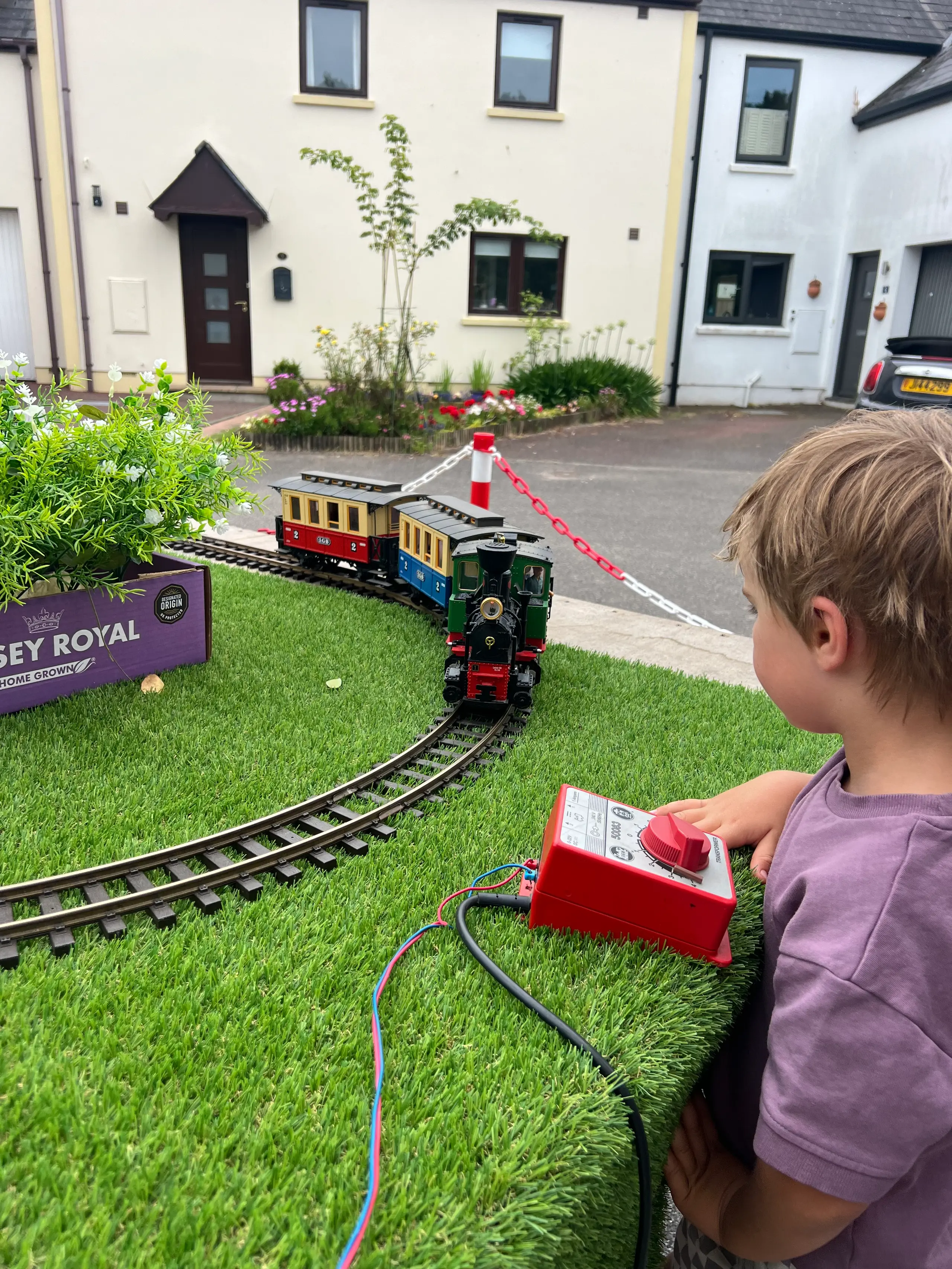 A child at the controls of the hands-on display layout at an open day