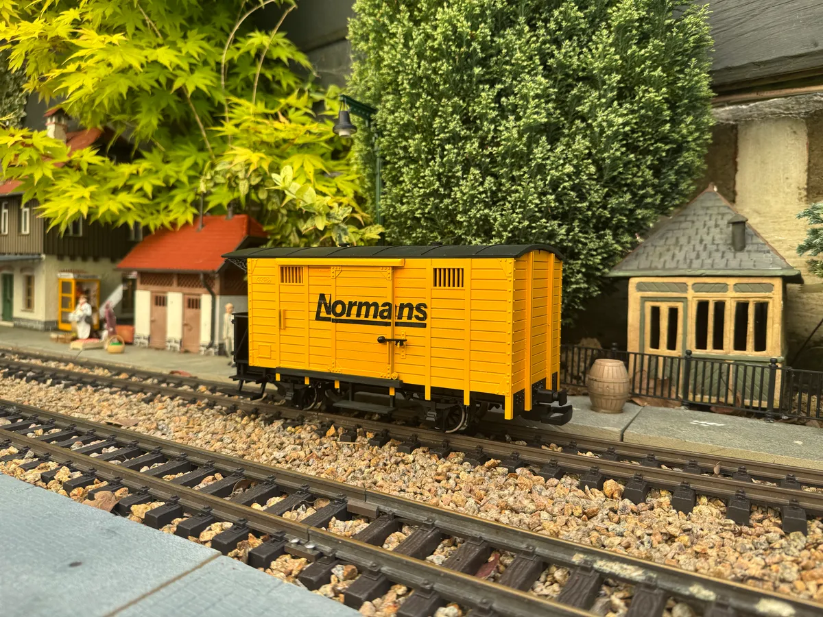 A garden railway wagon liveried for Norman's, a sponsoring business