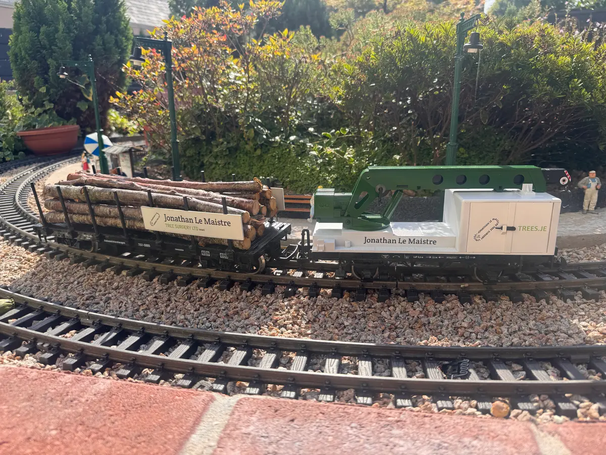 A garden railway wagon liveried for Jonathan Le Maistre Tree Surgeons, a sponsoring business