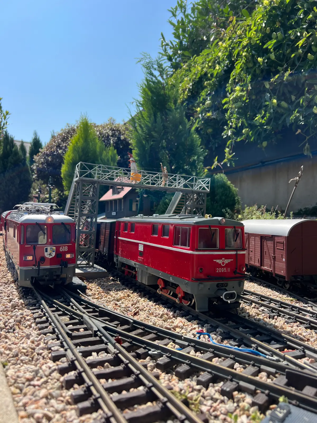 Two G Scale locomotives crossing a bridge on the layout