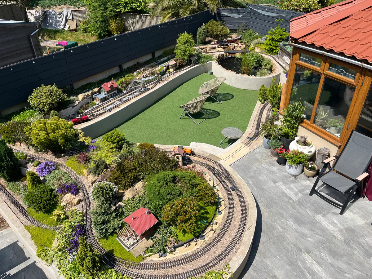 Aerial view of the garden railway layout, pond, and seating area